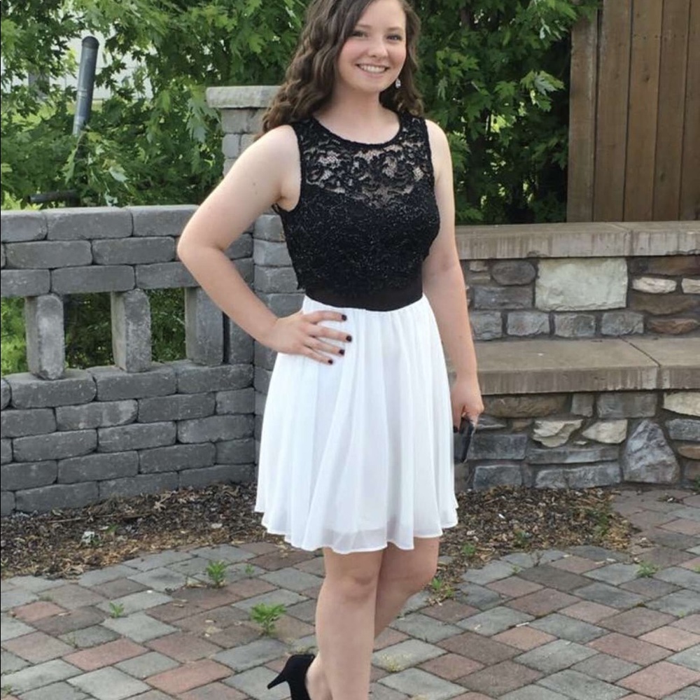Black sparkly top and white on the skirt part